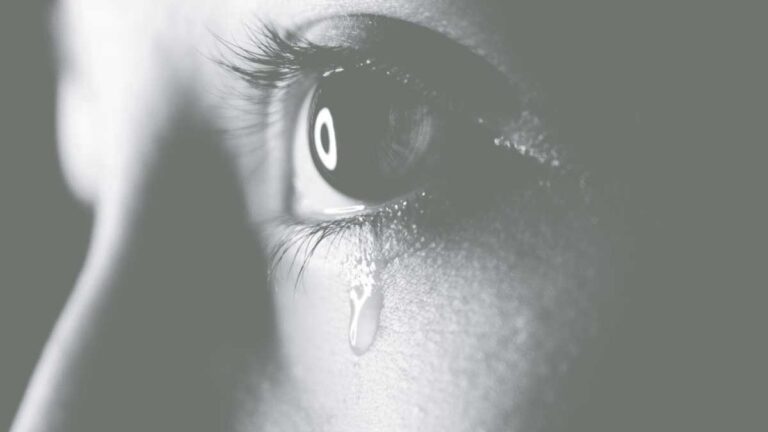 Closeup of eye with tear on cheek