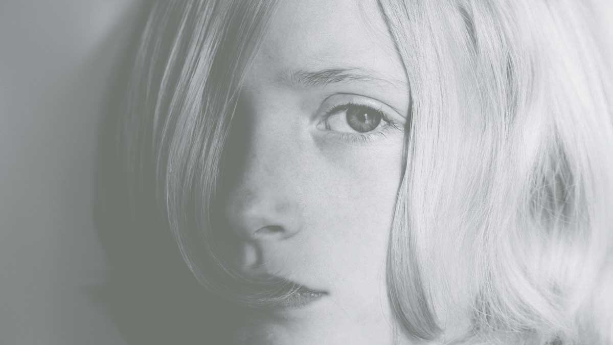 A boy looks into the camera forlornly